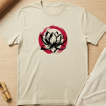 Beige t-shirt with a black and red lotus flower design on a wooden surface. Minimalist yoga apparel by pemuyo.
