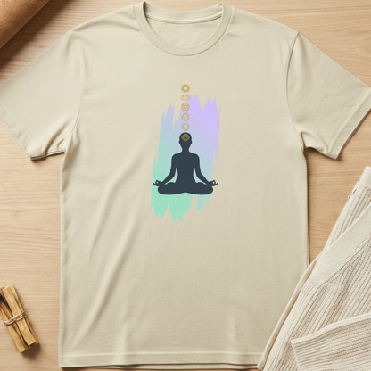 Beige t-shirt with a meditation graphic on a wooden surface. Minimalist yoga apparel by pemuyo.