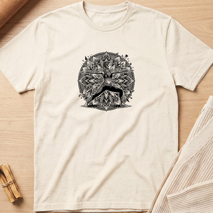An off-white short-sleeve t-shirt with a black circular graphic of a deer surrounded by geometric patterns, laid flat on a light wood background. Minimalist yoga apparel by pemuyo.