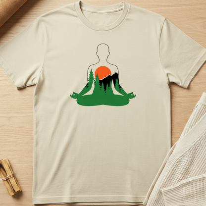 Beige t-shirt with a graphic design of a person meditating in nature on a wooden surface. Minimalist yoga apparel by pemuyo.