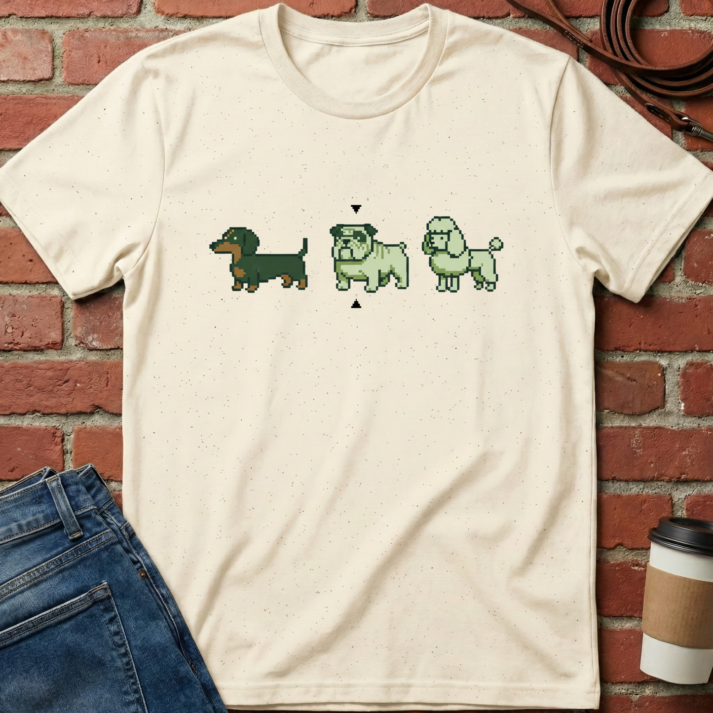 Beige t-shirt with pixelated dog graphics on a brick wall background. Minimalist dog apparel by pemuyo.