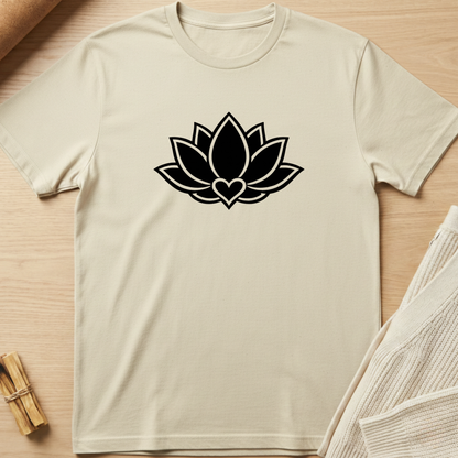 Beige t-shirt with a black lotus flower design on a wooden surface. Minimalist yoga apparel by pemuyo.