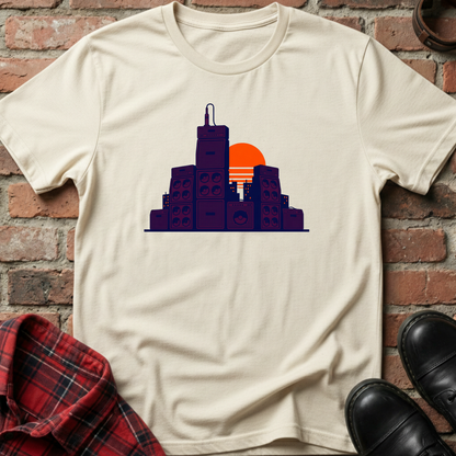 Beige t-shirt with cityscape design on a brick wall background. Minimalist music apparel by pemuyo.