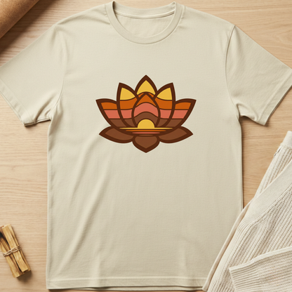 Beige t-shirt with a colorful lotus flower design on a wooden surface. Minimalist yoga apparel by pemuyo.