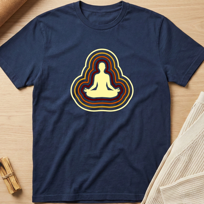 Navy blue t-shirt with a meditating figure design on a wooden surface. Minimalist yoga apparel by pemuyo.