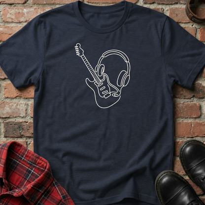 Navy blue t-shirt with white graphic design of a guitar and headphones on a brick background. Minimalist music apparel by pemuyo.