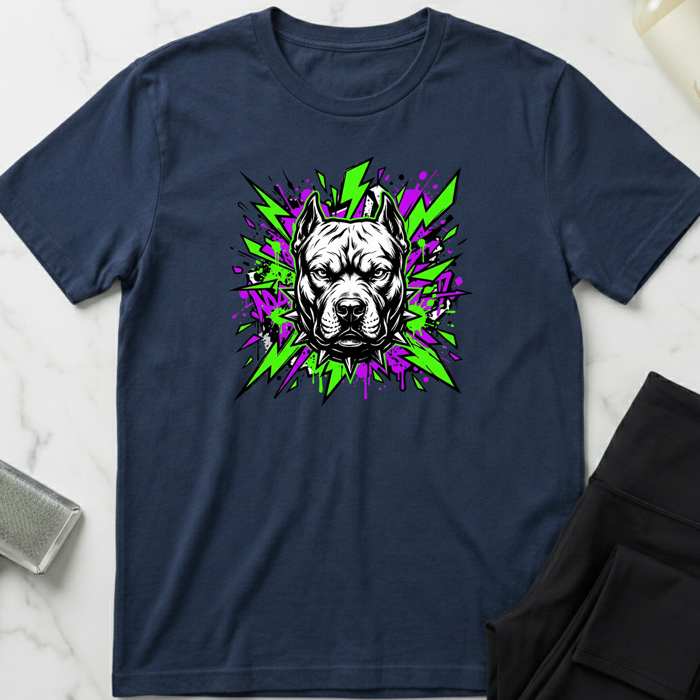 Navy blue t-shirt with a graphic of a dog's face on a white marble surface. Minimalist dog apparel by pemuyo.