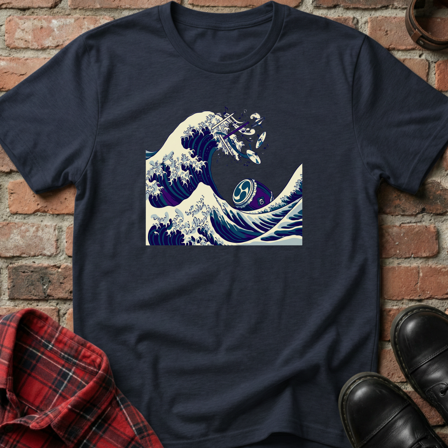 Navy blue t-shirt with wave design on a brick wall background. Minimalist music apparel by pemuyo.