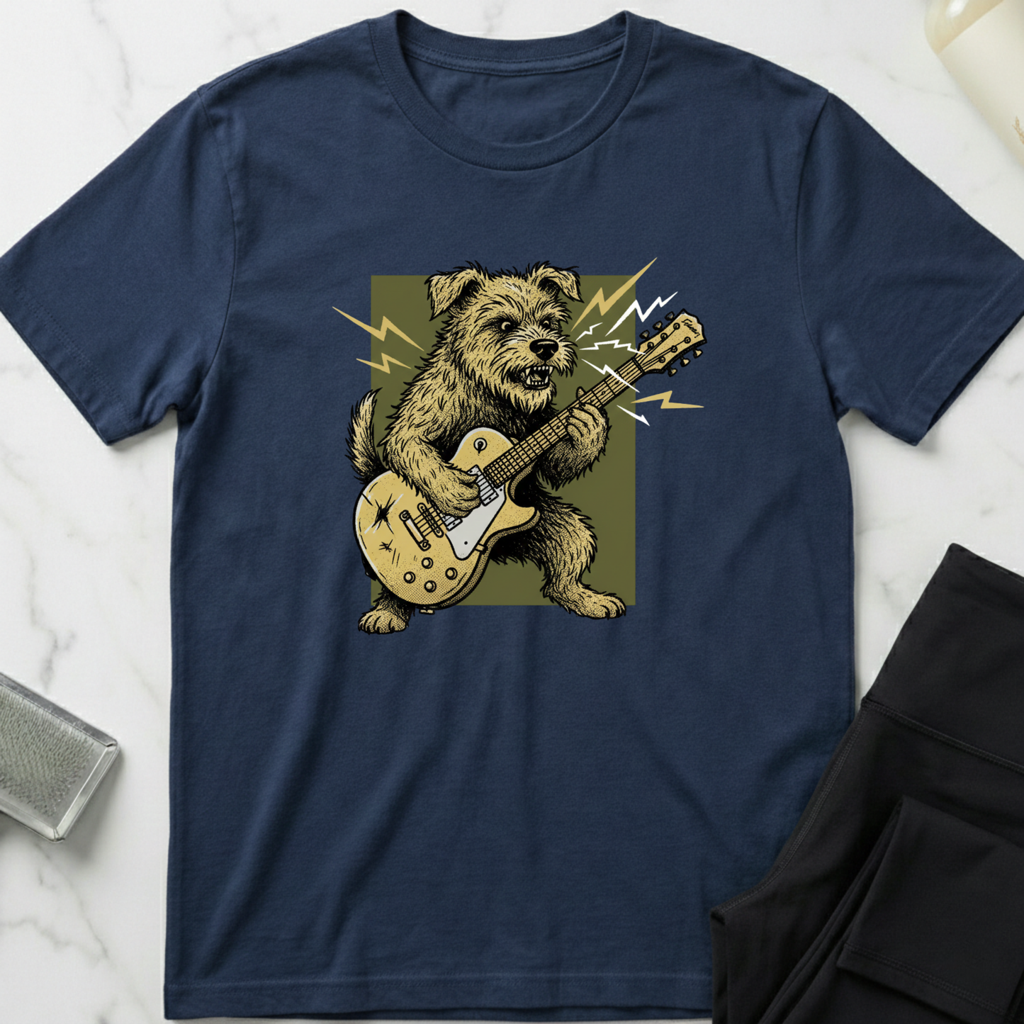 Navy blue t-shirt with a dog playing guitar graphic on a marble surface. Minimalist dog apparel by pemuyo.