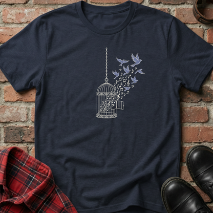 Navy blue t-shirt with a birdcage and flying birds design on a brick background. Minimalist music apparel by pemuyo.
