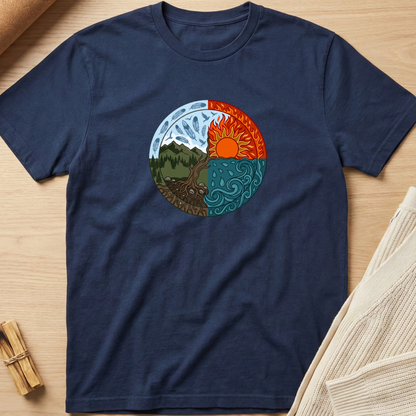 A navy blue short-sleeve t-shirt laid flat on a light wood surface, featuring a circular yin-yang style graphic on the chest with mountain, tree, sun, and swirling wind elements in blue, green, brown, orange, and red. Minimalist yoga apparel by pemuyo.