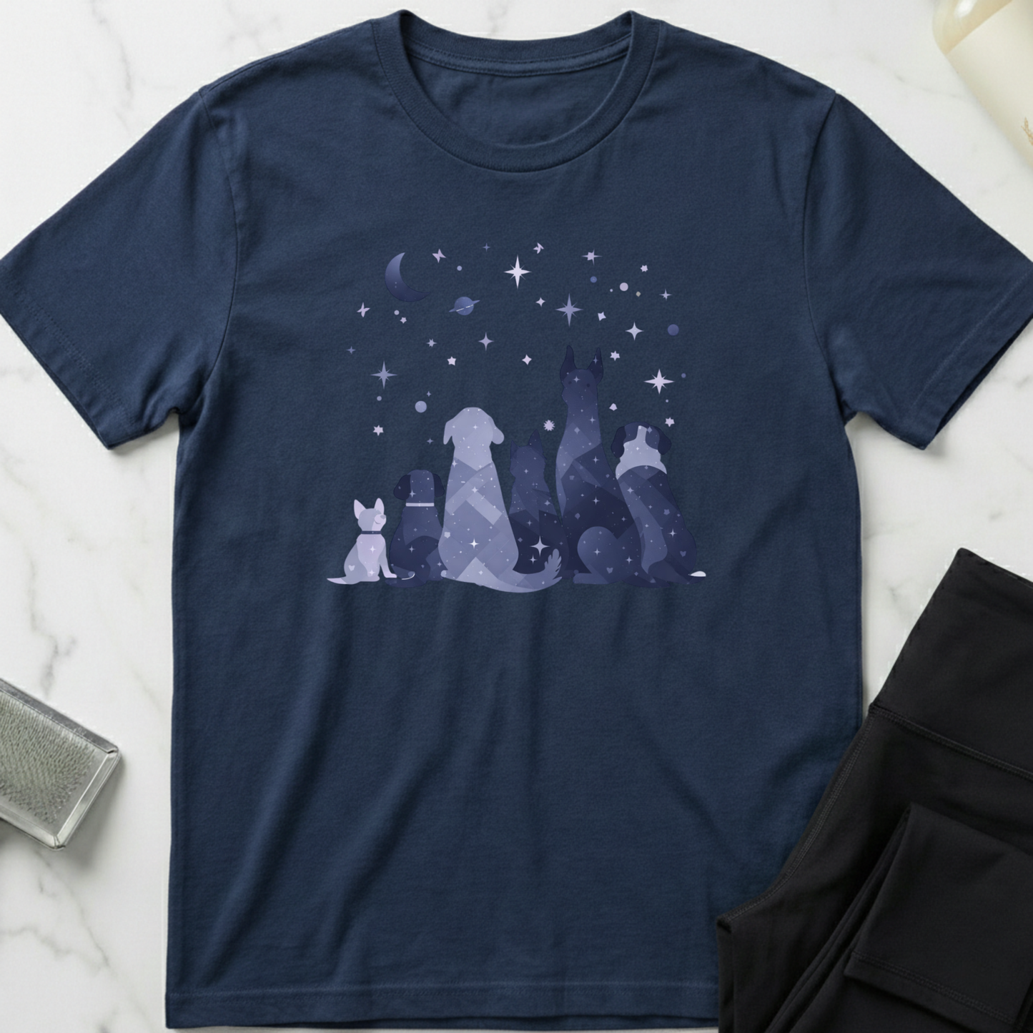 Navy blue t-shirt with geometric dogs design on a marble surface. Minimalist dog apparel by pemuyo.