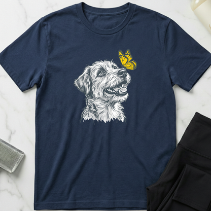 Navy blue t-shirt with a dog graphic and butterfly on a marble surface. Minimalist dog apparel by pemuyo.
