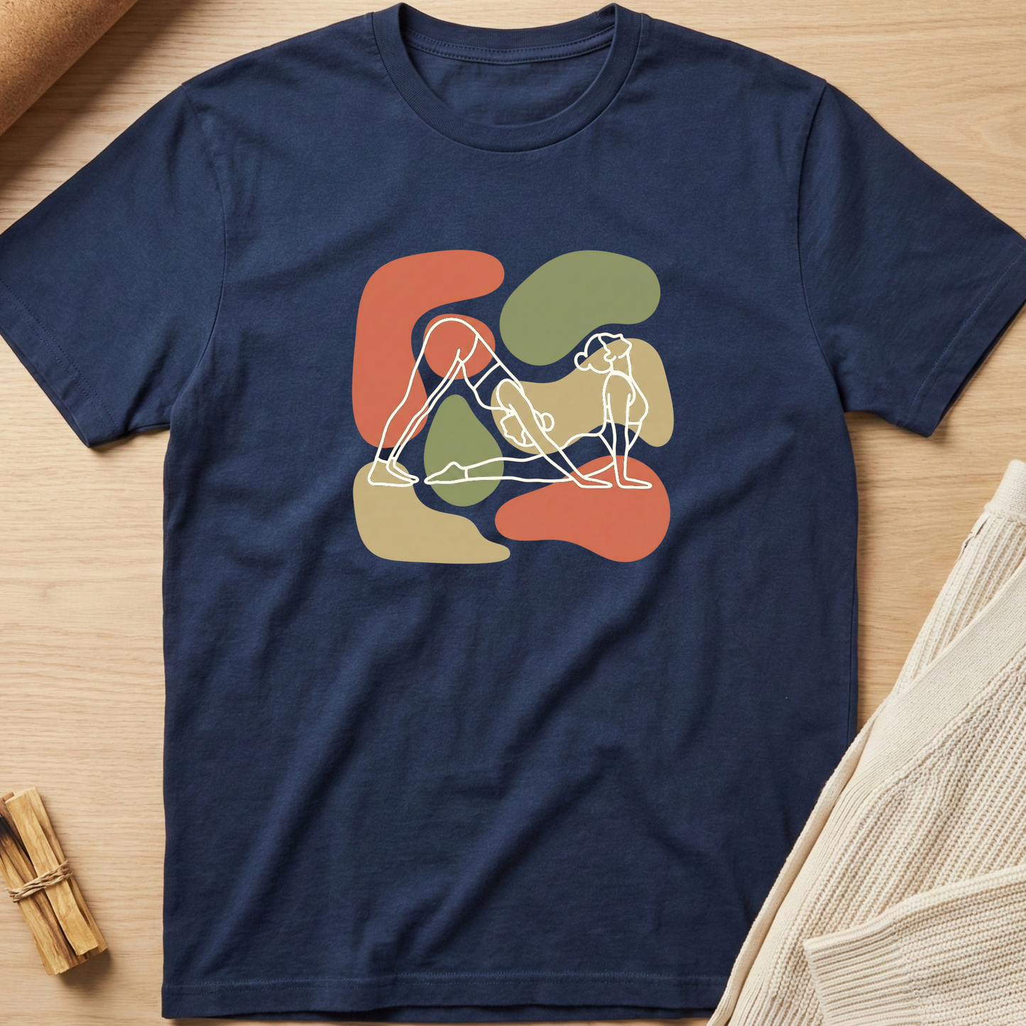 Navy blue t-shirt with abstract design on a wooden surface. Minimalist yoga apparel by pemuyo.