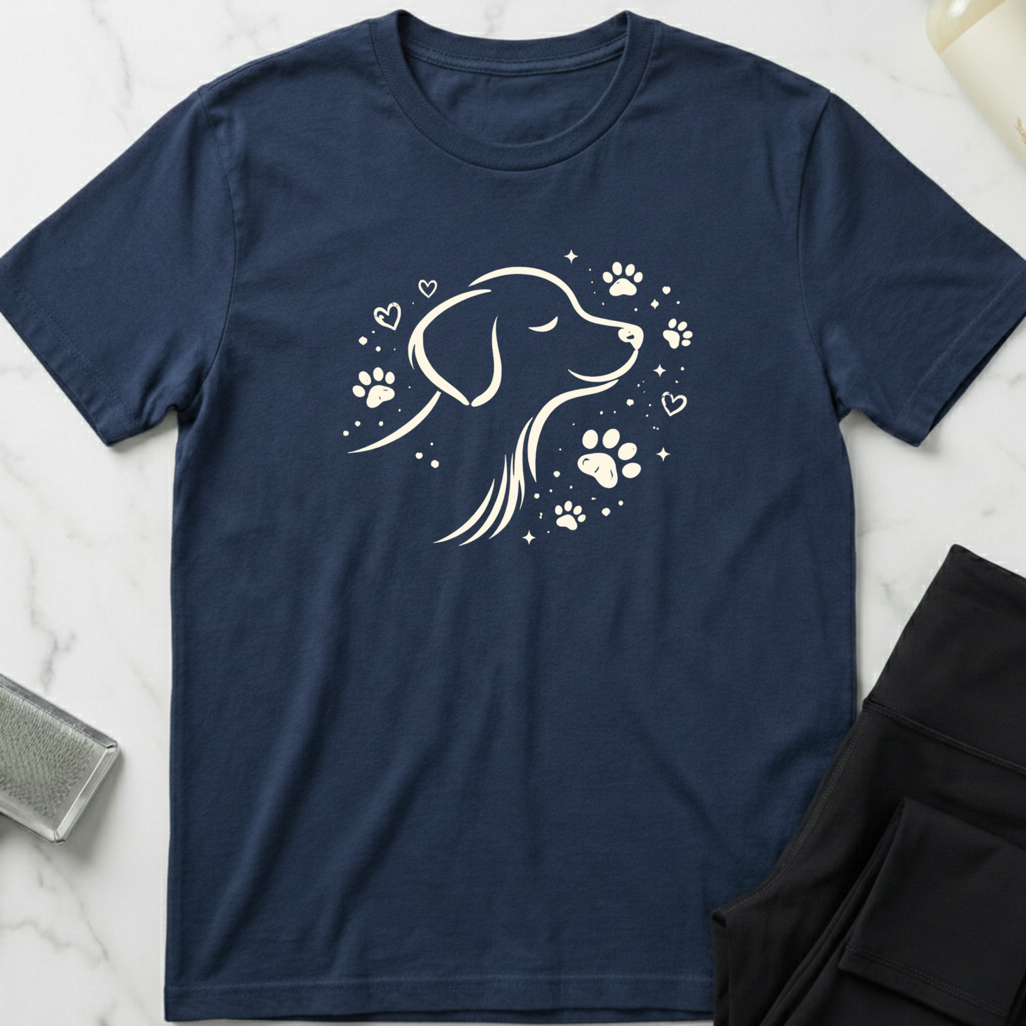 Navy blue t-shirt with a white dog illustration and paw prints on a marble surface. Minimalist dog apparel by pemuyo.