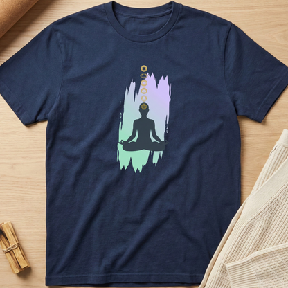 Navy blue t-shirt with a meditation graphic on a wooden surface. Minimalist yoga apparel by pemuyo.