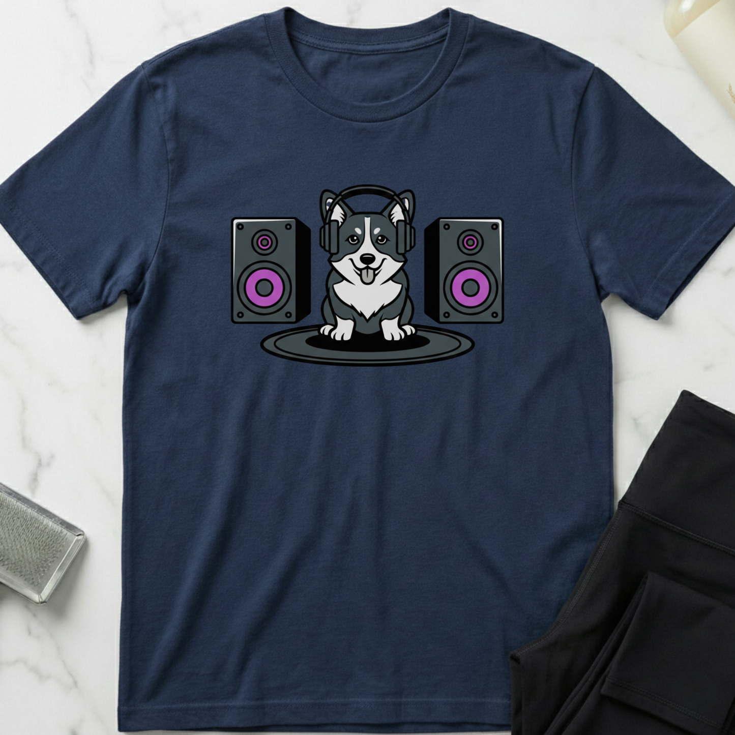 Navy blue t-shirt with a dog wearing headphones and speakers design on a marble surface. Minimalist dog apparel by pemuyo.
