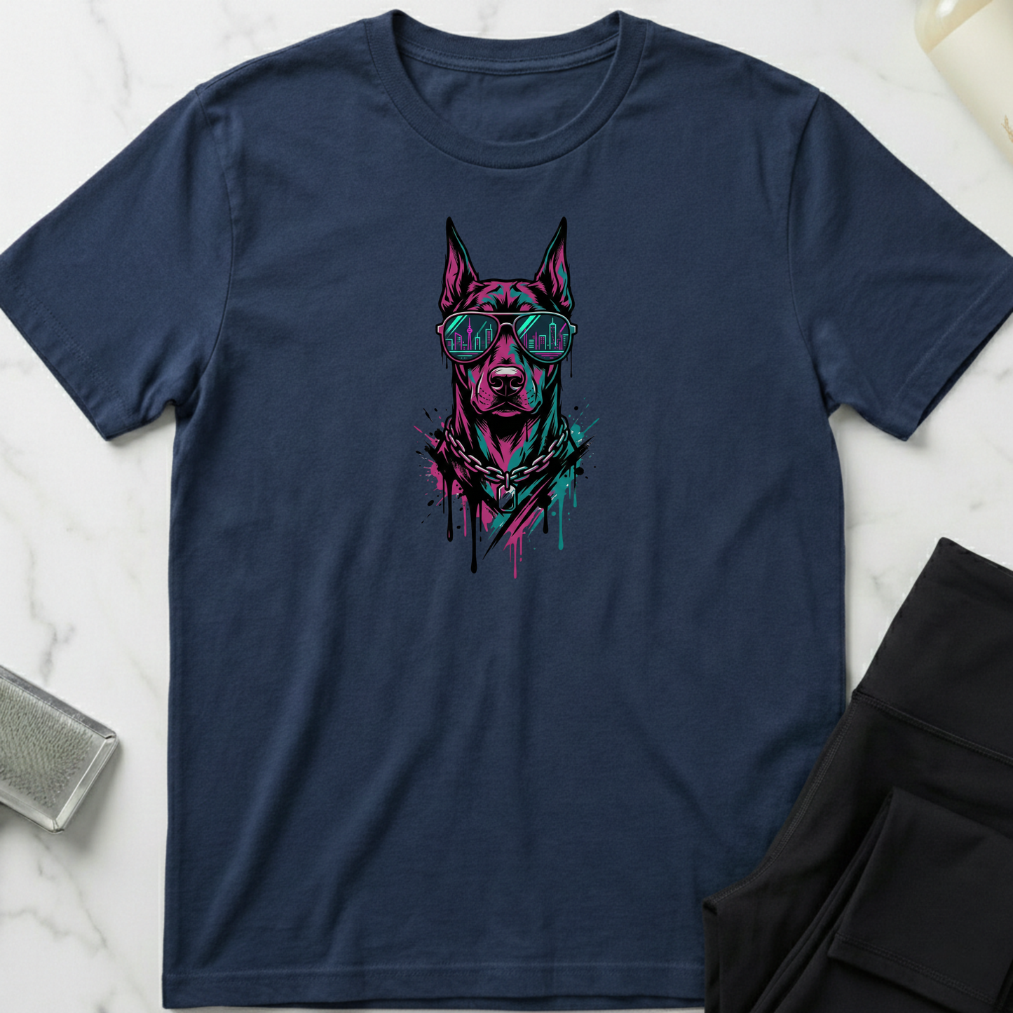 Navy blue t-shirt with a graphic of a dog wearing sunglasses on a marble surface. Minimalist dog apparel by pemuyo.