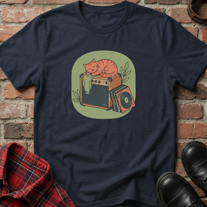 Navy blue t-shirt with a graphic of a cat on an amplifier against a brick wall. Minimalist music apparel by pemuyo.