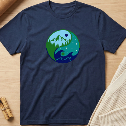 Navy blue t-shirt with a circular design featuring nature elements on a wooden surface. Minimalist yoga apparel by pemuyo.