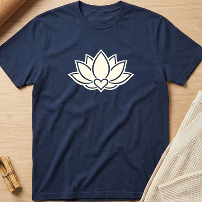 Navy blue t-shirt with a white lotus flower design on a wooden surface. Minimalist yoga apparel by pemuyo.