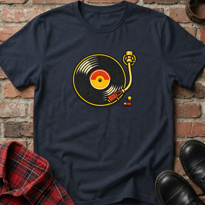 Navy blue t-shirt with vinyl record design on a brick wall background. Minimalist music apparel by pemuyo.