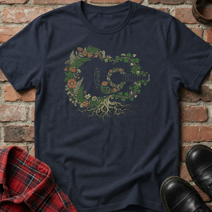 Navy blue t-shirt with a floral and guitar design against a brick wall. Minimalist music apparel by pemuyo.