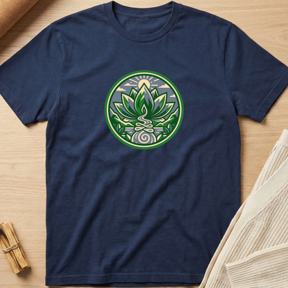A navy blue crewneck t-shirt laid flat on a light wood surface, featuring a circular green and white lotus meditative graphic printed on the chest. Minimalist yoga apparel by pemuyo.