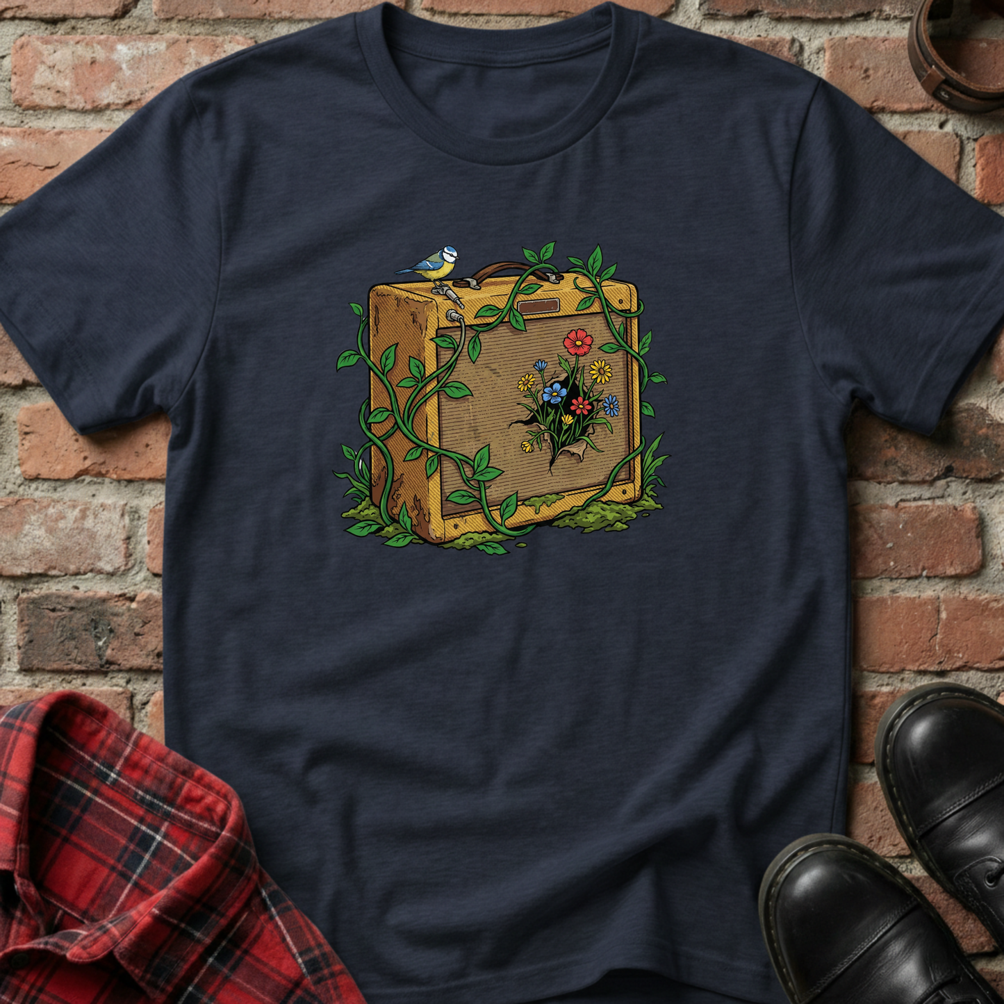 Navy blue t-shirt with a vintage suitcase and floral design against a brick wall. Minimalist music apparel by pemuyo.