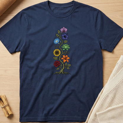Navy blue t-shirt with colorful floral embroidery on a wooden surface. Minimalist yoga apparel by pemuyo.