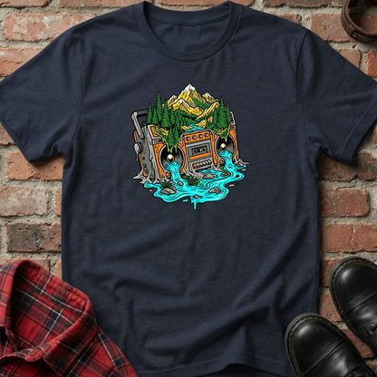 Navy blue t-shirt with a graphic design of a cassette tape with mountains and trees on a brick background. Minimalist music apparel by pemuyo.