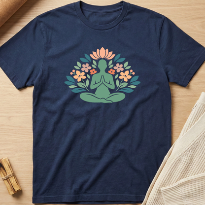 Navy blue t-shirt with a green figure in a meditative pose surrounded by flowers on a wooden surface. Minimalist yoga apparel by pemuyo.
