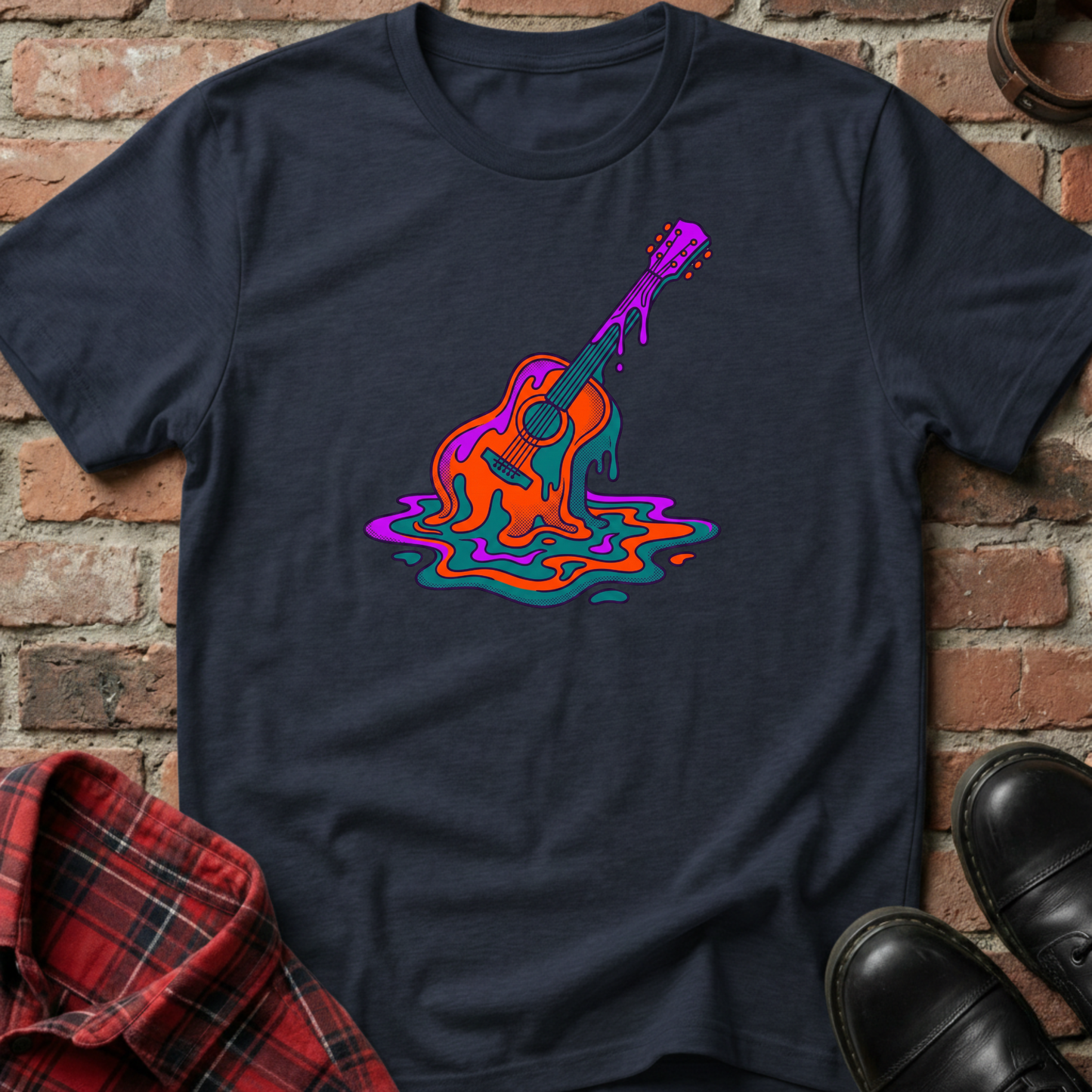 Black t-shirt with colorful guitar design on a brick wall background. Minimalist music apparel by pemuyo.