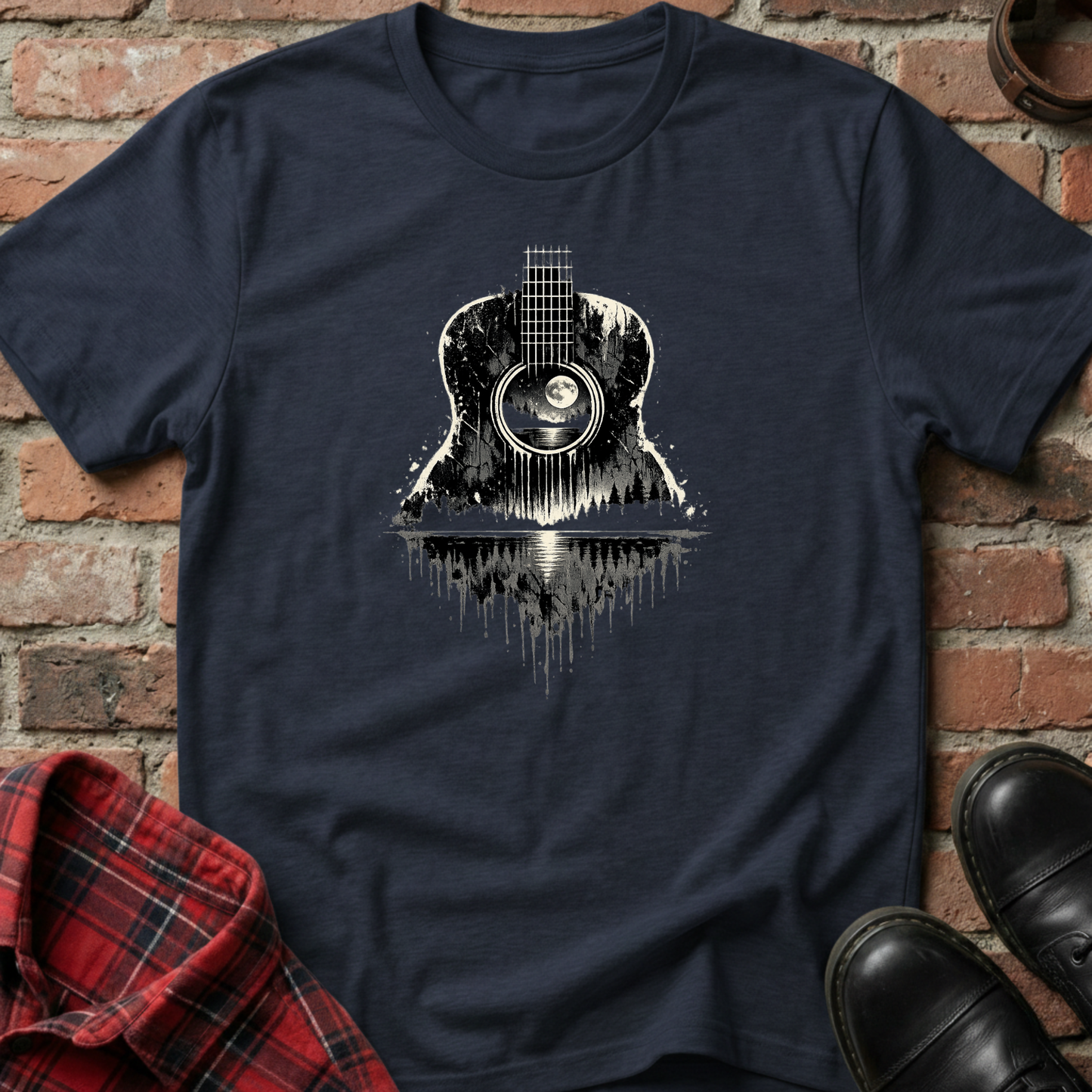 Navy blue t-shirt with guitar graphic on a brick wall background. Minimalist music apparel by pemuyo.