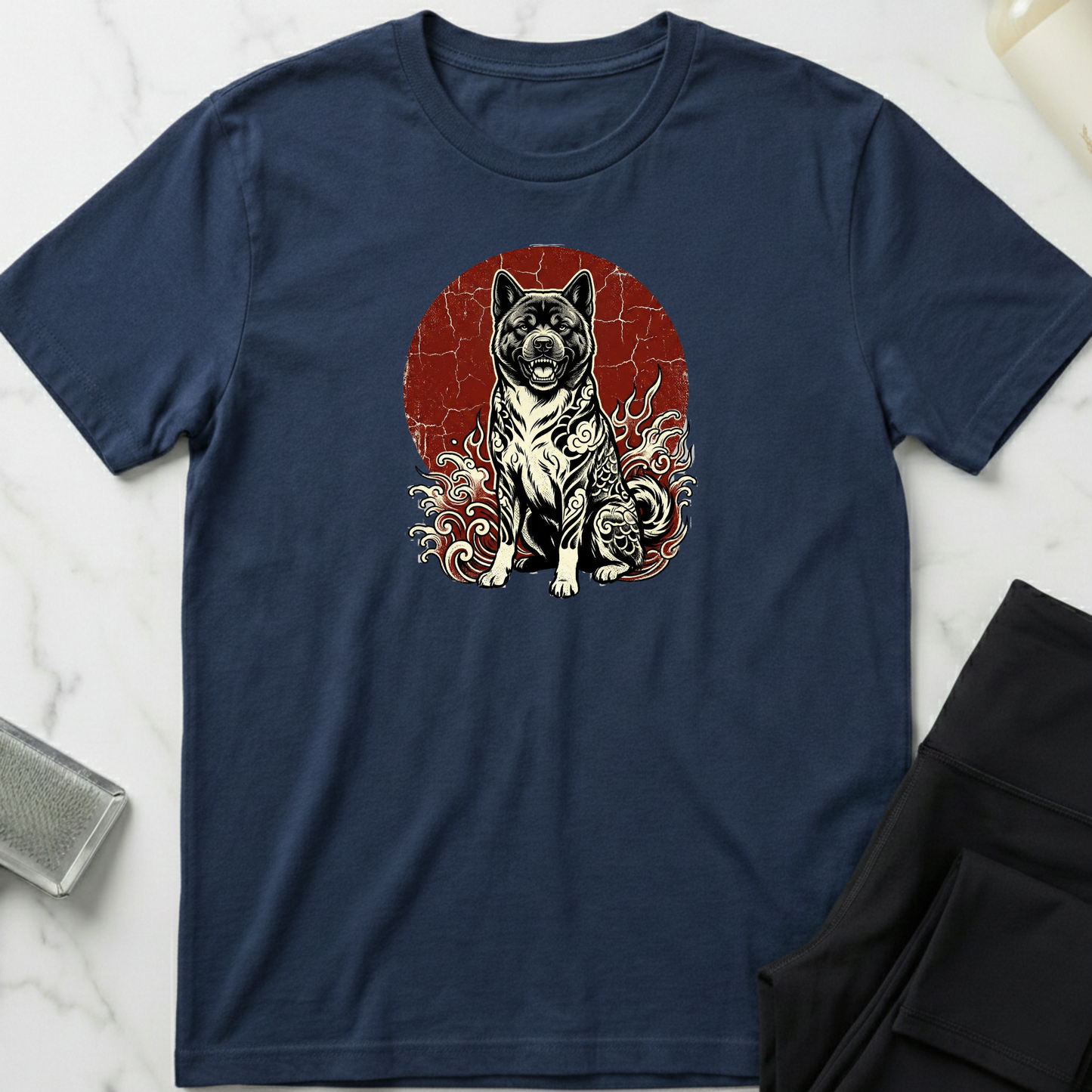 Navy blue t-shirt with a graphic of a dog on a red background, placed on a marble surface. Minimalist dog apparel by pemuyo.