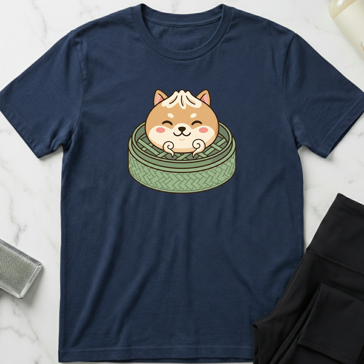 Navy blue t-shirt with a cartoon dog design on a marble surface. Minimalist dog apparel by pemuyo.