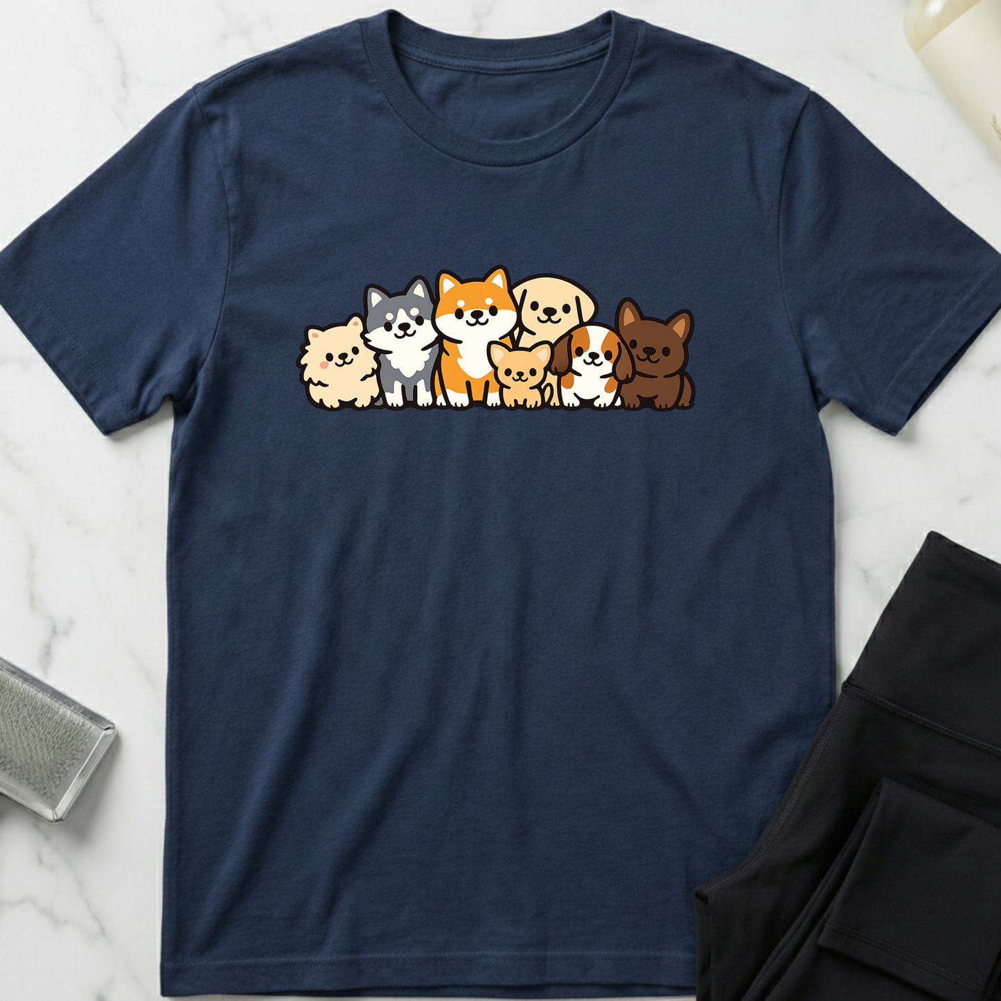 Navy blue t-shirt with cartoon dog illustrations on a marble surface. Minimalist dog apparel by pemuyo.