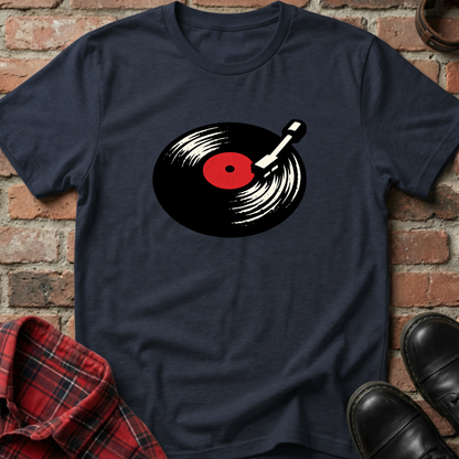 Navy blue t-shirt with vinyl record design on a brick surface. Minimalist music apparel by pemuyo.