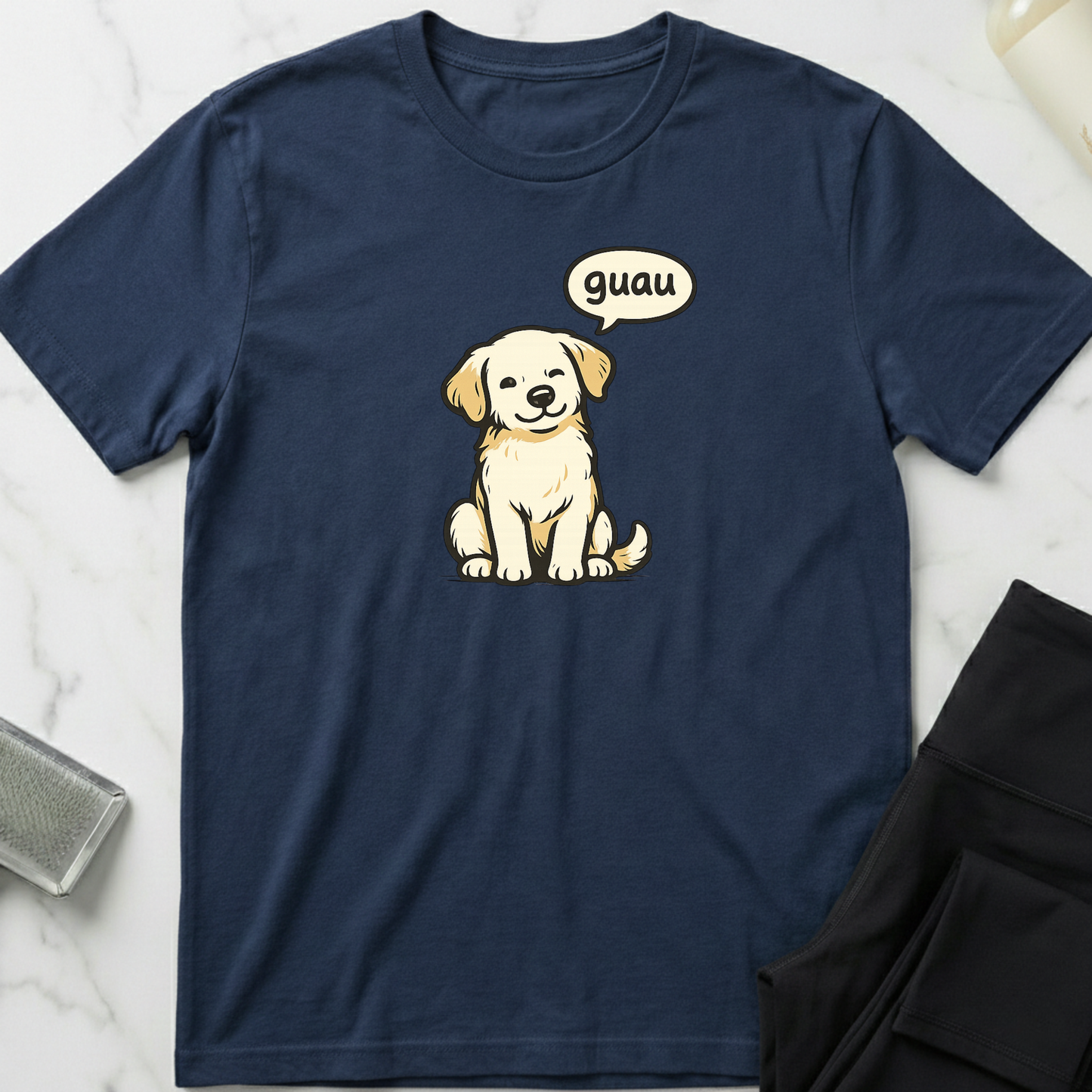 Navy blue t-shirt with a cartoon dog and 'guau' speech bubble on a marble surface. Minimalist dog apparel by pemuyo.