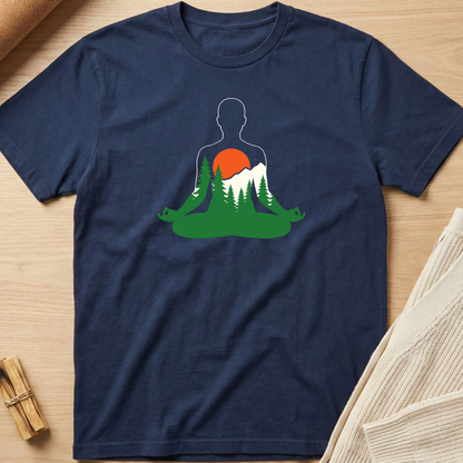 Navy blue t-shirt with a silhouette of a person meditating in nature design on a wooden surface. Minimalist yoga apparel by pemuyo.