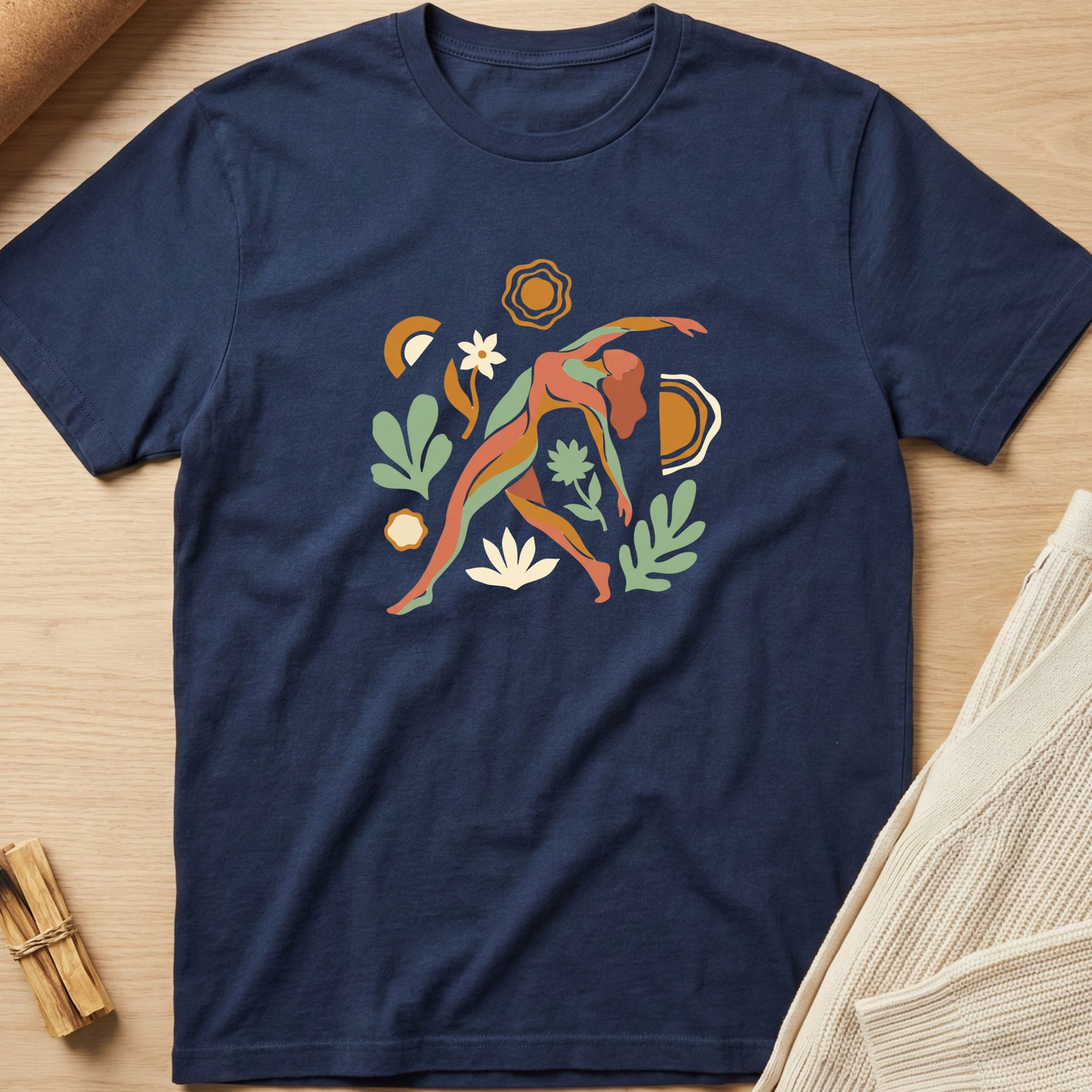 Navy blue t-shirt with colorful abstract design on a wooden surface. Minimalist yoga apparel by pemuyo.
