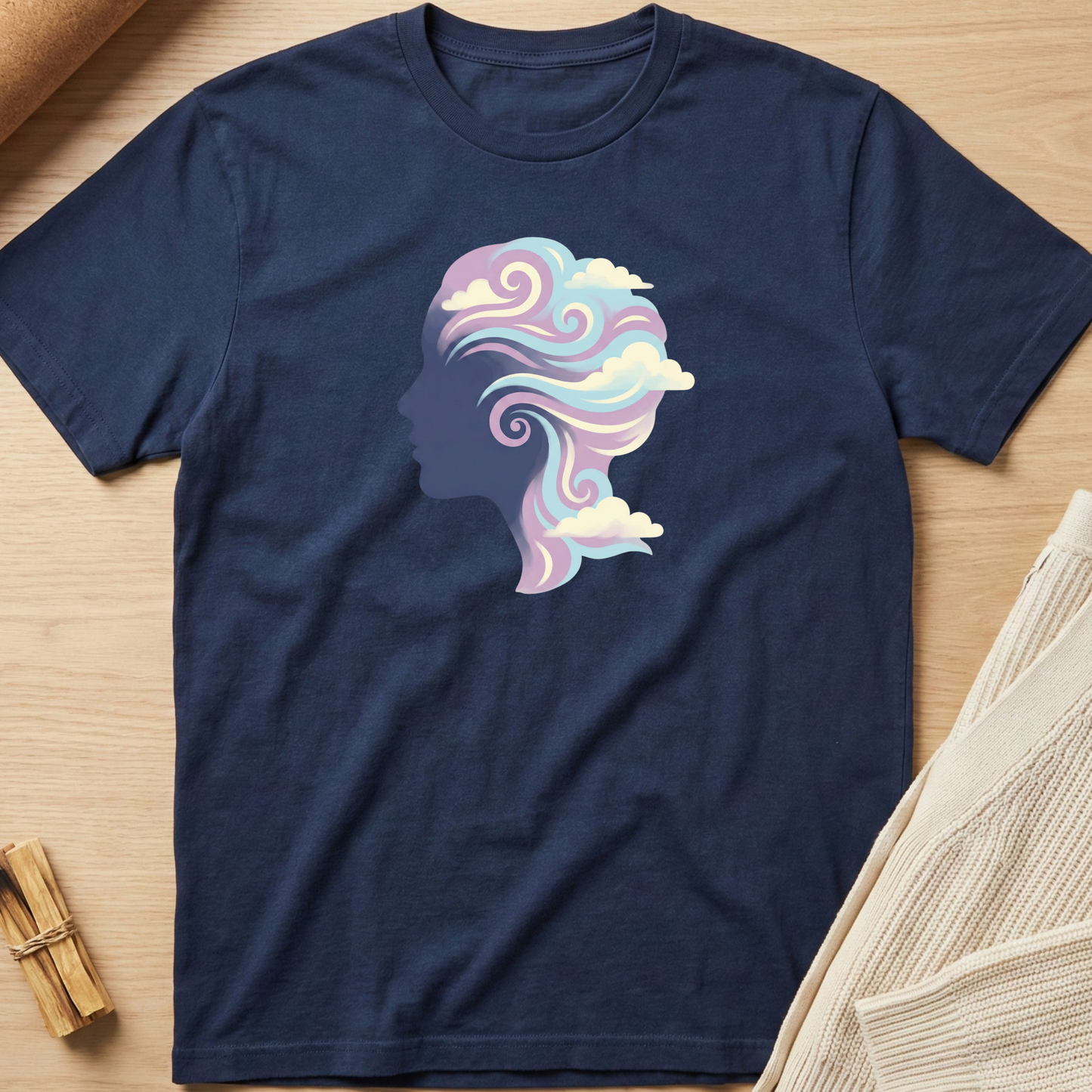 Navy blue t-shirt with a colorful silhouette design on a wooden surface. Minimalist yoga apparel by pemuyo.