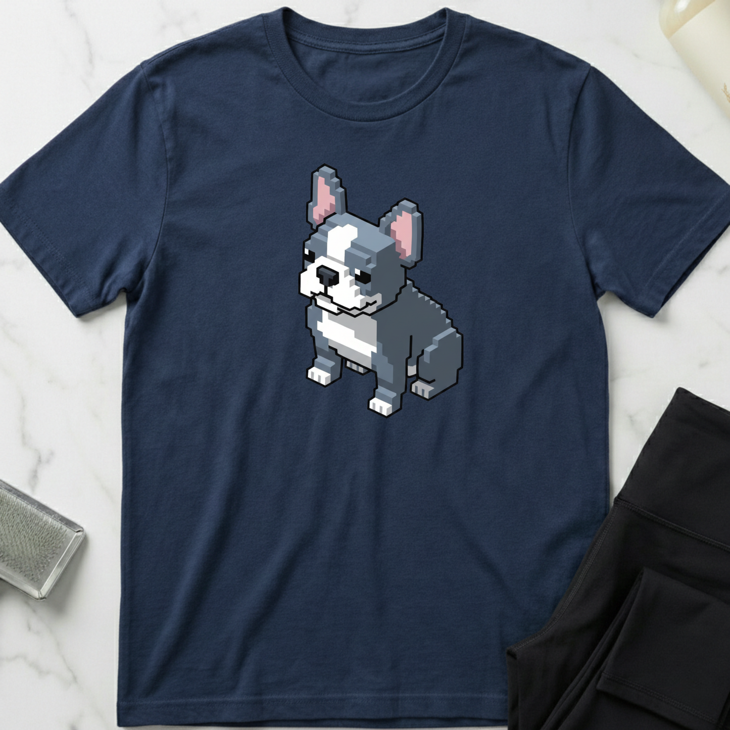 Navy blue t-shirt with a pixelated dog design on a marble surface. Minimalist dog apparel by pemuyo.