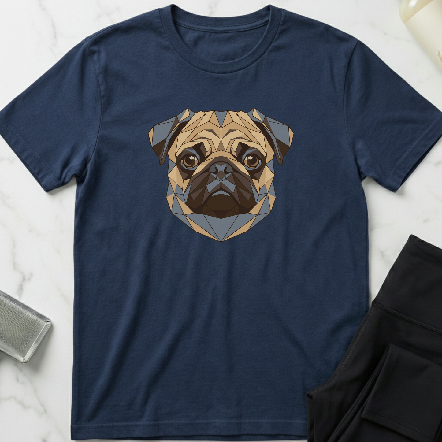 Navy blue t-shirt with a geometric pug design on a marble surface. Minimalist dog apparel by pemuyo.
