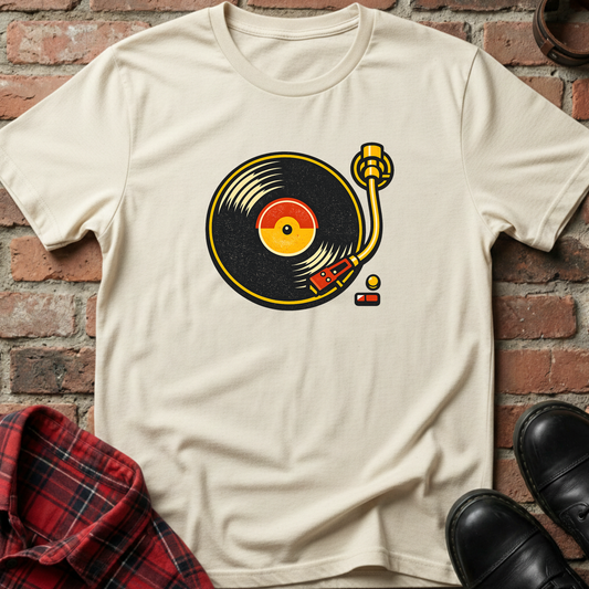 Beige t-shirt with a vinyl record graphic on a brick wall background. Minimalist music apparel by pemuyo.