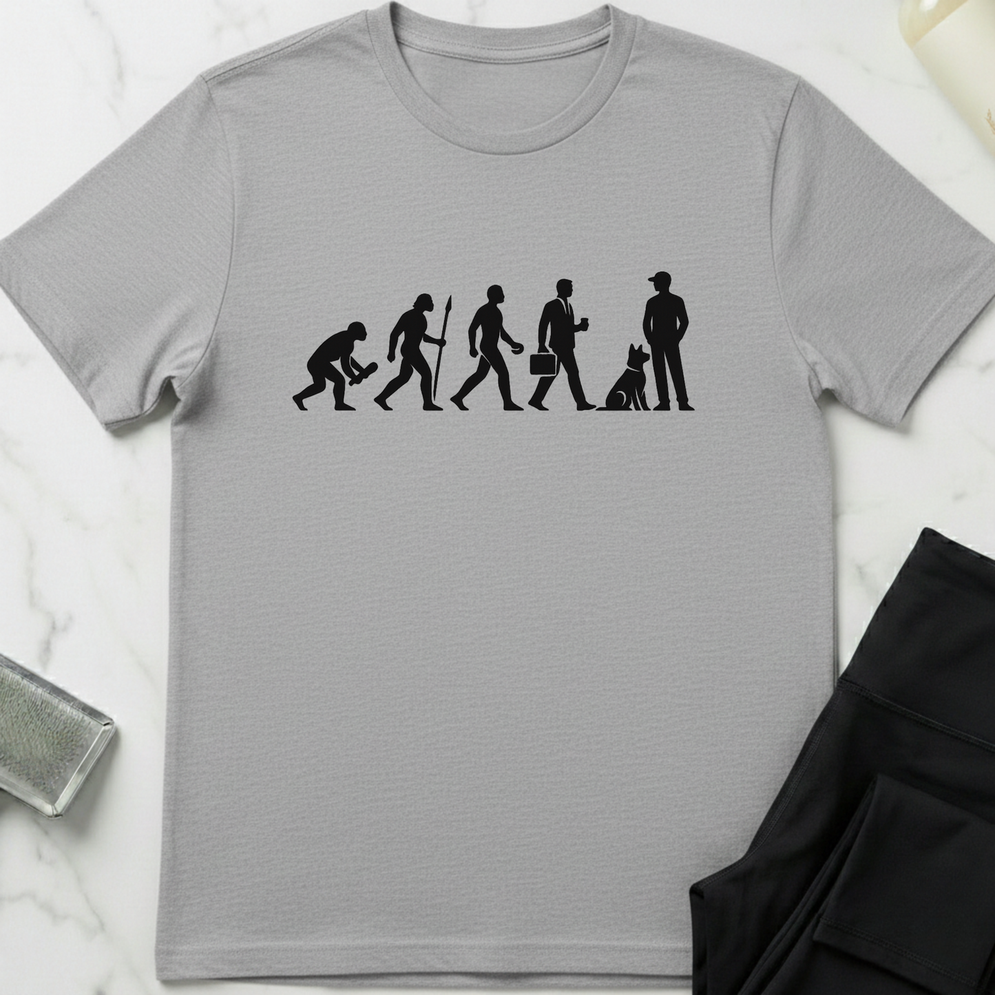 Gray t-shirt with black graphic design on a white marble surface. Minimalist dog apparel by pemuyo.
