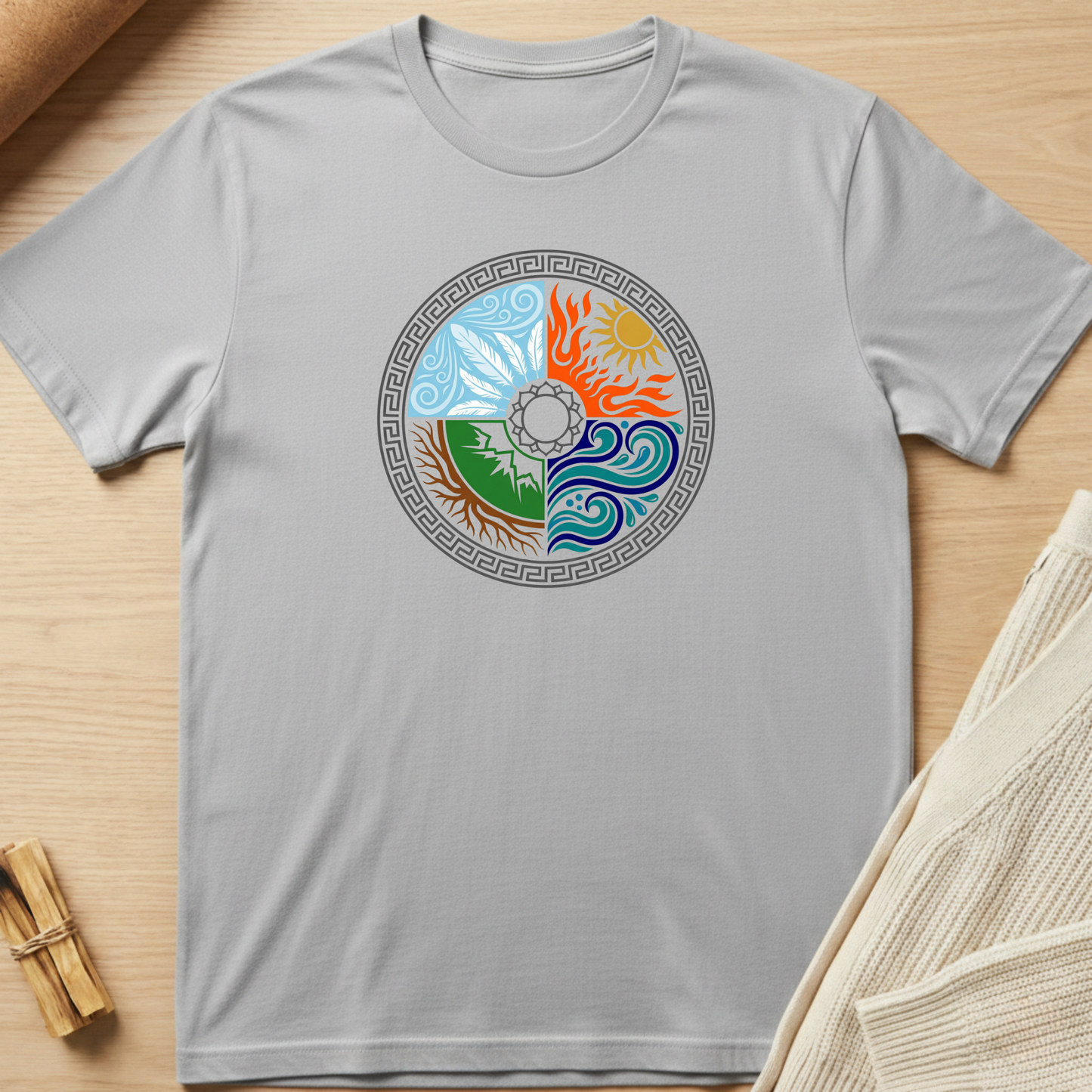 Gray t-shirt with a colorful circular design on a wooden surface. Minimalist yoga apparel by pemuyo.