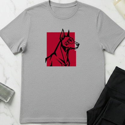 Gray t-shirt with a red and black dog graphic on a white marble surface. Minimalist dog apparel by pemuyo.