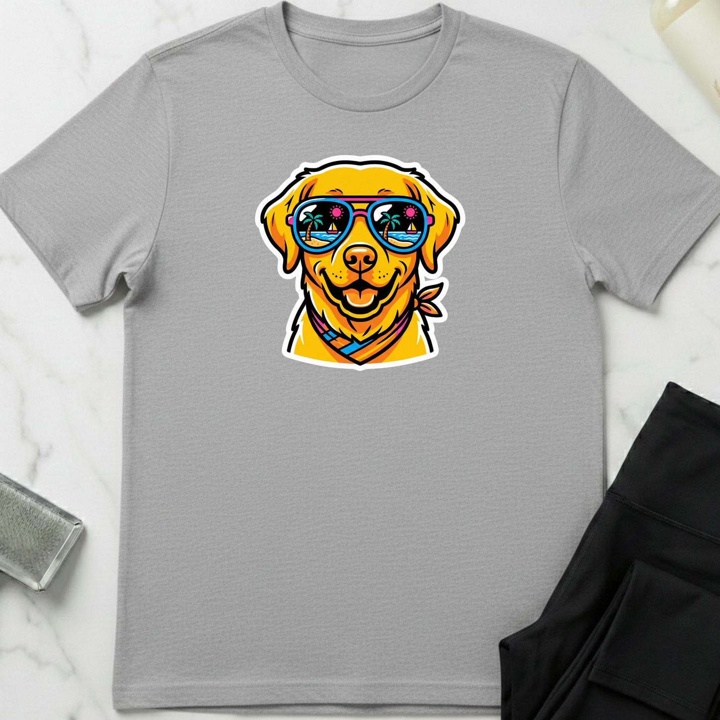 Gray t-shirt with a dog wearing sunglasses graphic on a marble surface. Minimalist dog apparel by pemuyo.