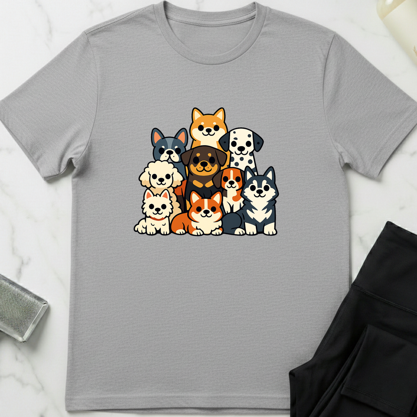 Gray t-shirt with cartoon dog illustrations on a white marble surface. Minimalist dog apparel by pemuyo.